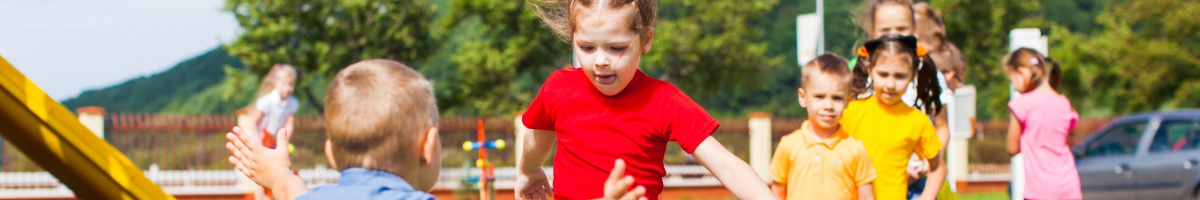 Elementary aged kids play hopscotch at recess.