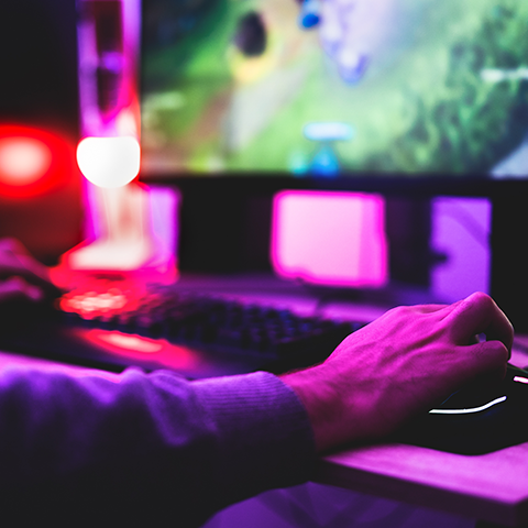 An arm reaching out to a computer keyboard.