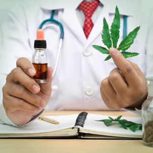 Lab person holding CBD and cannabis leaf